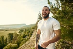 Young bearded man portrait outdoors in the mountains